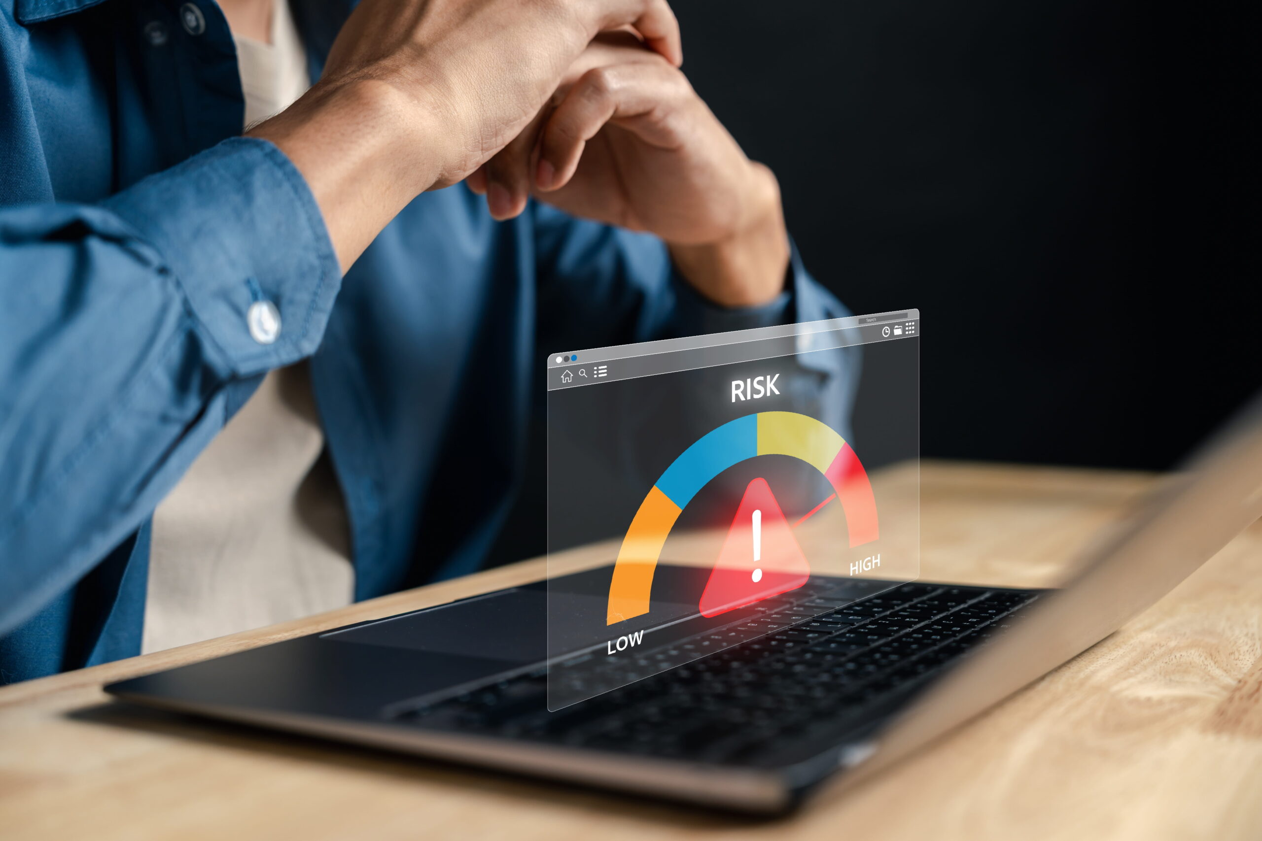 cybersecurity managed services showcased on laptop showing risk meter, with woman looking closely